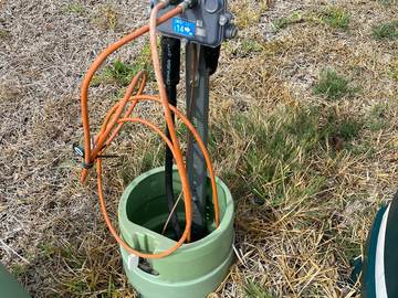 Green pedestal enclosure with drop cabling at a residential tap